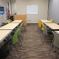 two horizontal rows of tables lined with chairs
