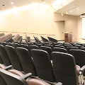 empty chairs in auditorium looking toward screen
