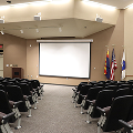 empty chairs in auditorium looking toward screen