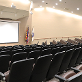 empty chairs in auditorium looking toward screen