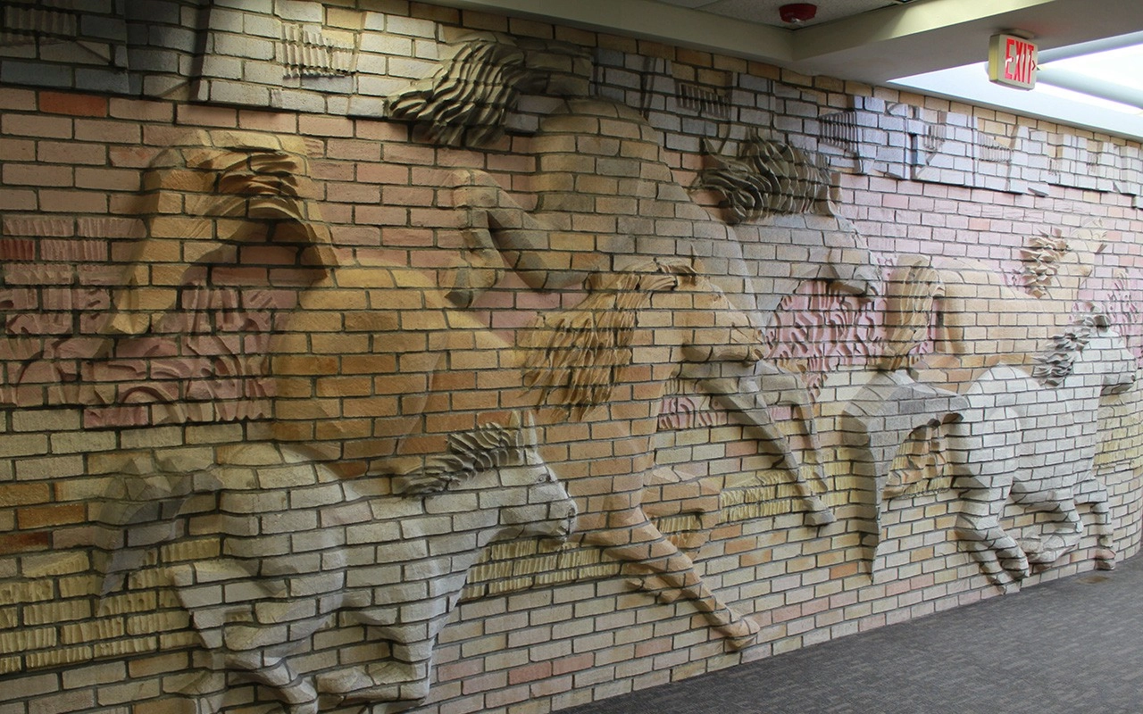 brick wall with artistic horses embossed
