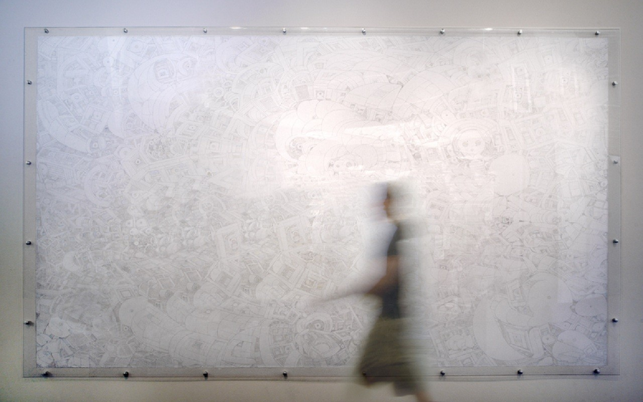 Blurred person walking in front of a large, complex line drawing.