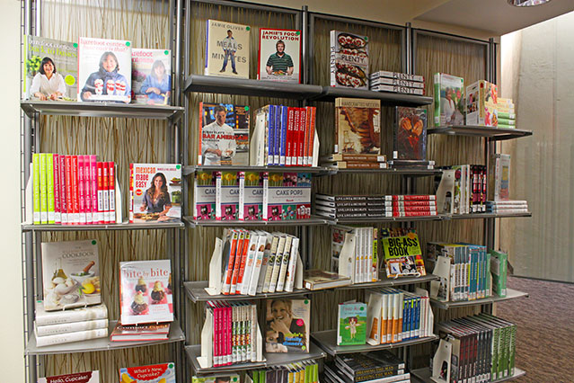 Each library has a shop like this with books and media for sale to support your local library. books displayed on a bookshelf like a book store